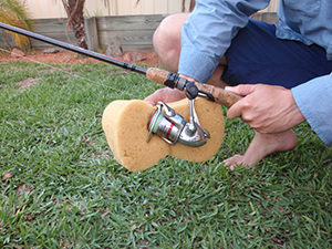 Fishing rod being cleaned with sponge